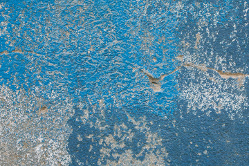 Old cracked wall painted in blue and white as texture and background. Close up view. 