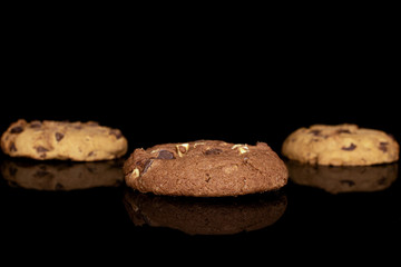 Group of three whole sweet brown cookie isolated on black glass
