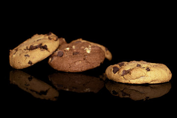 Group of three whole sweet brown cookie isolated on black glass