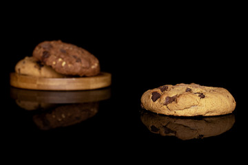 Group of three whole sweet brown cookie isolated on black glass