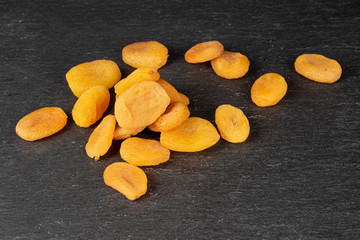 Lot of whole dried orange apricot on grey stone