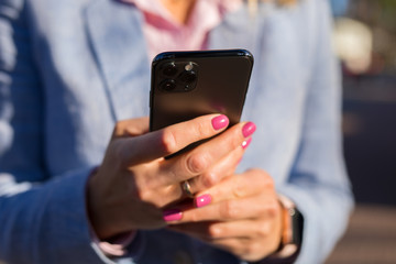Person holding and using modern smartphone
