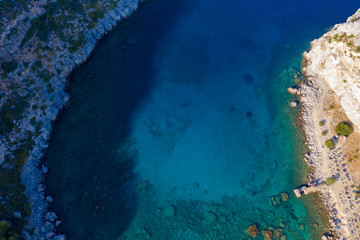 beautiful Bay of Greek island view from drone with bird's eye view. Sea, rocks, vegetation and turquoise sea.