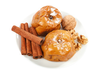 Baked apples nuts cinnamon on a Christmas table