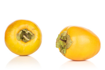 Group of two whole sweet orange persimmon isolated on white background