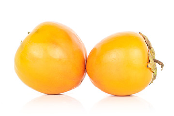Group of two whole sweet orange persimmon isolated on white background