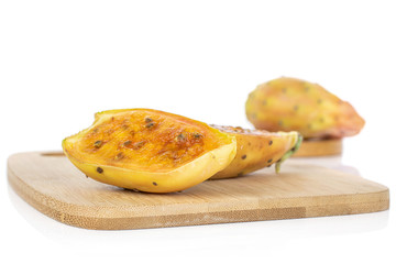 Group of one whole two halves of prickly green opuntia on bamboo cutting board isolated on white background