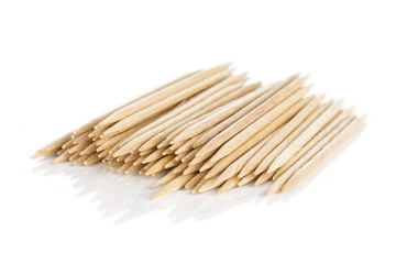 Lot of whole wooden brown toothpick isolated on white background