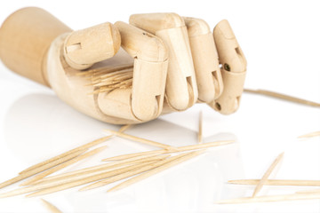 Lot of whole disordered wooden brown toothpick with wooden hand isolated on white background