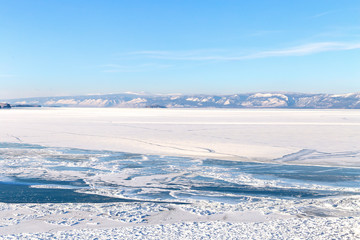 Fototapeta na wymiar Winter landscape with lake covered with ice.Lake Baikal, Russia