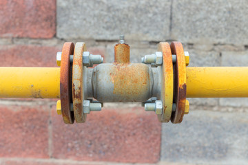 Natural gas valve painted in yellow color, closeup