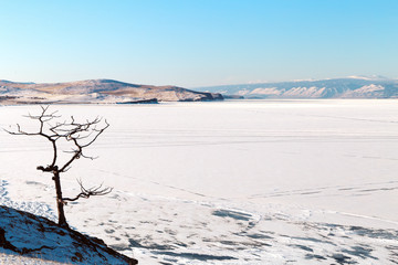 Winter landscape with lake covered with ice.Lake Baikal, Russia