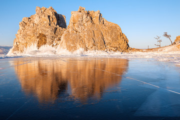 Winter Baikal. Olkhon Island. Reflection on the ice Shamanka rock