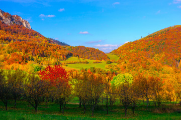 Sunny autumn day in mountain landscape. Colorful leaves of trees and clear blue sky. Mountain Vrsatec, Slovakia.
