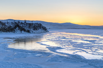 Colorful sunset over the crystal ice of Baikal lake