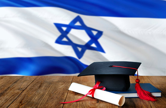 Israel Education Concept. Graduation Cap And Diploma On Wooden Table, National Flag Background. Succesful Student.