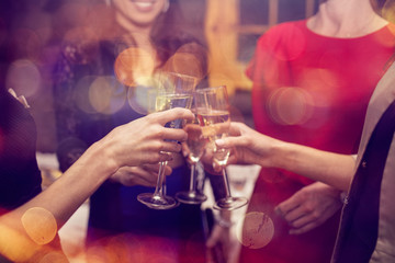 New Year eve party with champagne. Woman's celebrating and toasting with champagne flutes