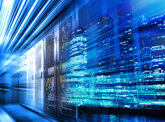 Light trails on modern building background and data center servers are on move. Concept big data in motion. Blue toning