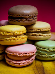 Fototapeta premium Colored macarons isolated on wooden dish, typical French dish