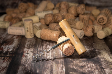 Fototapeta na wymiar corkscrew and corks on wooden background