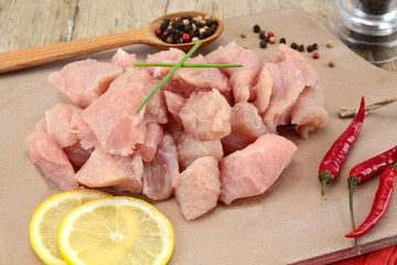 raw chicken fillet cut into pieces on a cutting board