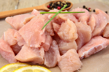 raw chicken fillet cut into pieces on a cutting board