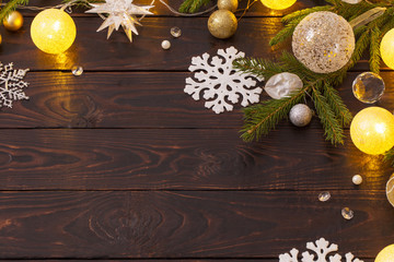 Christmas decorations with lights on dark wooden background