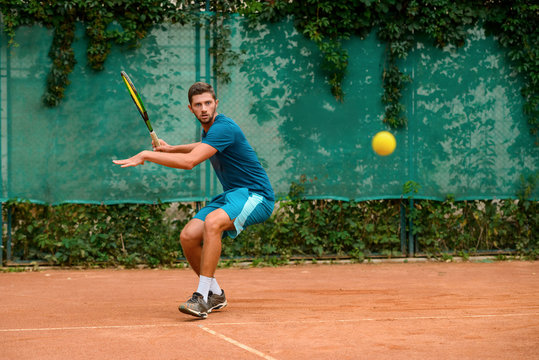 Tennis player about to hit the ball back.