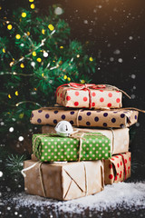 Christmas present on dark wooden background in vintage style. Merry Christmas and happy New year. Selective focus.