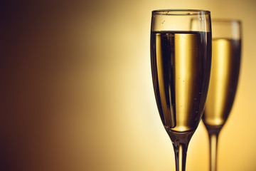 Two glasses of champagne on a blurred background. Celebration concept. Selective focus. Background with copy space.