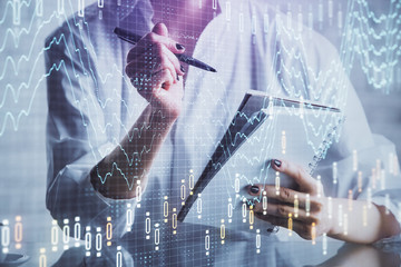 Financial chart drawn over hands taking notes background. Concept of research. Multi exposure