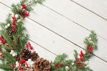 Christmas wreath on white wooden backdrop
