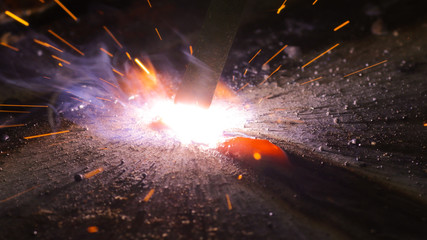 Welding metal macro background. Industrial welding light sparks.