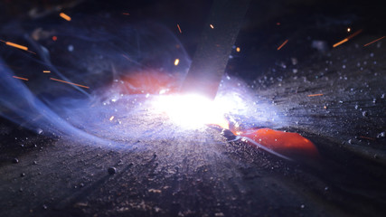 Fototapeta na wymiar Welding metal macro background. Industrial welding light sparks.