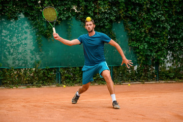 Young player practicing his tennis skills on the court