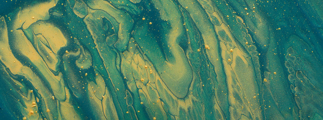 art photography of abstract marbleized effect background. emerald, green and gold creative colors. Beautiful paint.