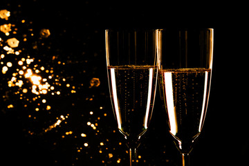 Glasses with champagne on black background, New Year background