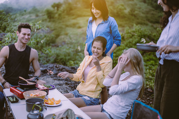 Cheerful of diversity best friends cooking food for breakfast at outdoor together,Enjoying camping concept