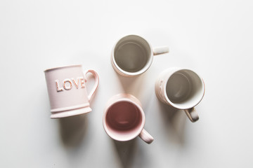 pink cups with love, white background. concept of romantic meeting, love, romantic breakfast
