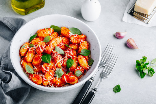 Traditional Italian potato Gnocchi with tomato sauce, parmesan cheese and fresh basil - Powered by Adobe