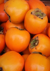 closeup of persimmons on display at the market