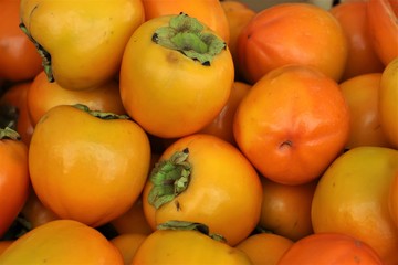closeup of persimmons on display at the market