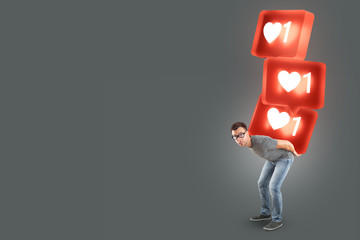 Man carrying a stack of large social media like symbols