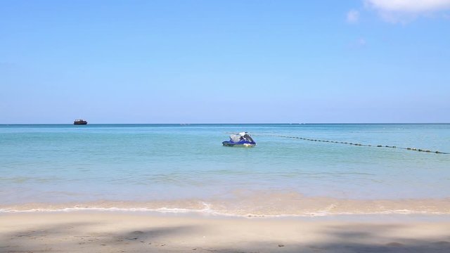 A hydrocycle near the shore sways in the waves on a clear sunny day. Water bike in the sea.
