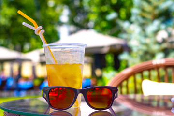 sunglasses and cocktail on a beach