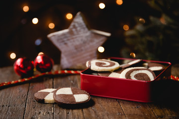 German christmas biscuits, checkered cookies, with homely decoration on wooden table
