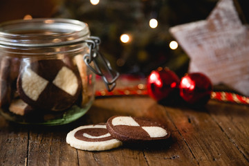 German christmas biscuits, checkered cookies, with homely decoration on wooden table