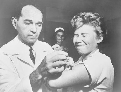 A nurse at Montefiore Hospital receives a flu vaccination in 1957