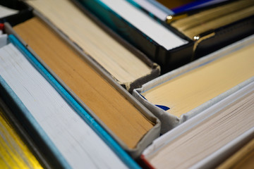 Old and used hardcover books. Stack of books background. many books piles. Old books and textbooks in hardcover. view from the top. Education concept. Close up