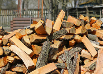 Firewood background - chopped firewood on a stack